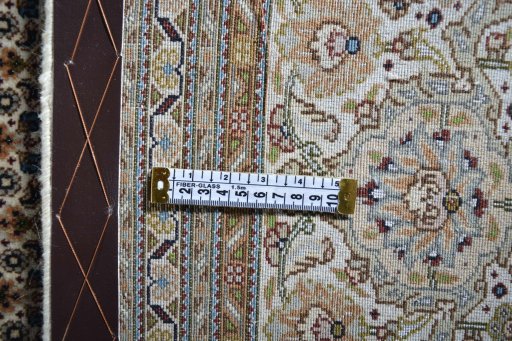 Backside of handmade 2000s Tabriz rug showing knot structure and weave density