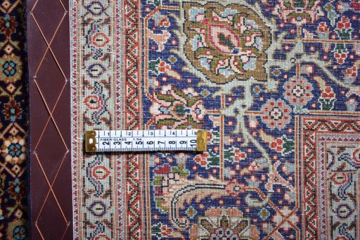 Backside of handmade New Tabriz rug showing knot structure and weave density