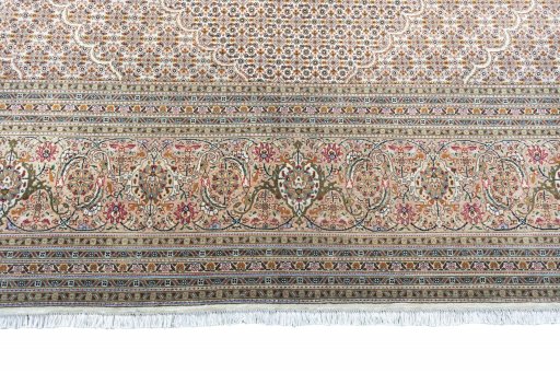 Corner detail of 2000s Tabriz rug showing border pattern and Cork pile