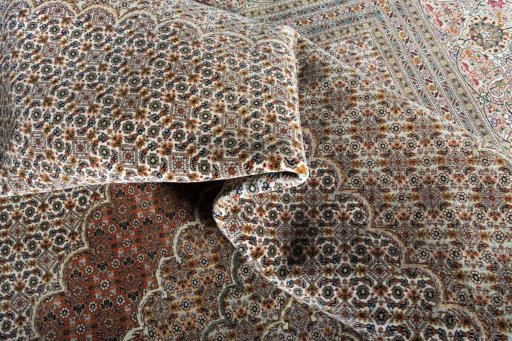 Backside of handmade 2000s Tabriz rug showing knot structure and weave density