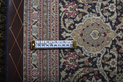 Backside of handmade New Tabriz rug showing knot structure and weave density