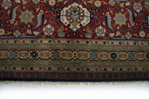 Corner detail of 1930s Tabriz rug showing border pattern and Wool pile
