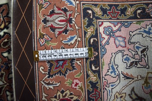 Backside of handmade New Tabriz rug showing knot structure and weave density