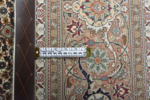 Backside of handmade New Tabriz rug showing knot structure and weave density