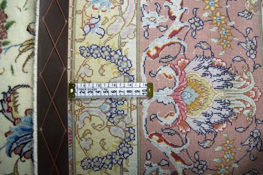 Backside of handmade New Tabriz rug showing knot structure and weave density