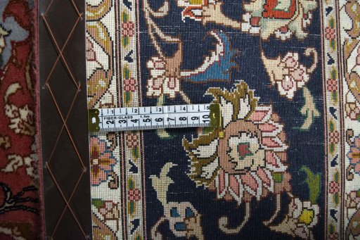 Backside of handmade New Tabriz rug showing knot structure and weave density