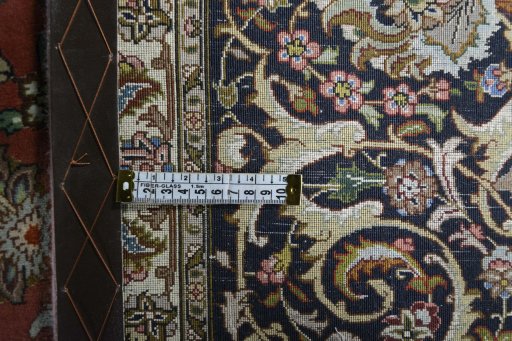 Backside of handmade New Tabriz rug showing knot structure and weave density