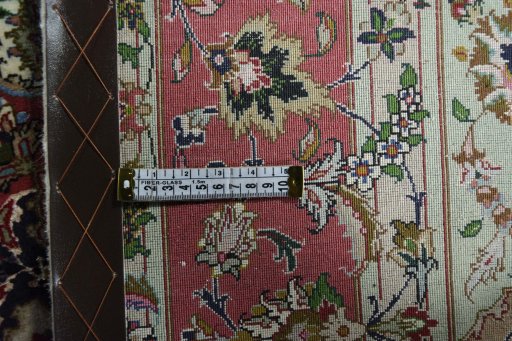 Backside of handmade New Tabriz rug showing knot structure and weave density