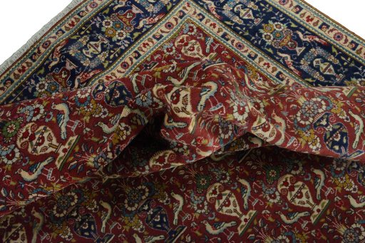 Corner detail of 2000s Tabriz rug showing border pattern and Wool pile