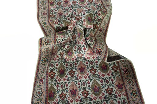 Corner detail of 2000s Tabriz rug showing border pattern and Wool pile