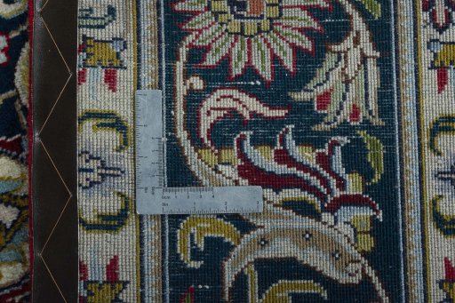 Backside of handmade 2000s Tabriz rug showing knot structure and weave density