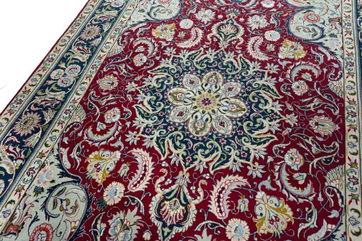 Backside of handmade 2000s Tabriz rug showing knot structure and weave density