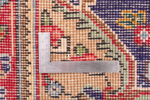 Corner detail of 1996s Tabriz rug showing border pattern and Wool pile