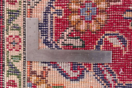 Corner detail of 2002s Tabriz rug showing border pattern and Wool pile