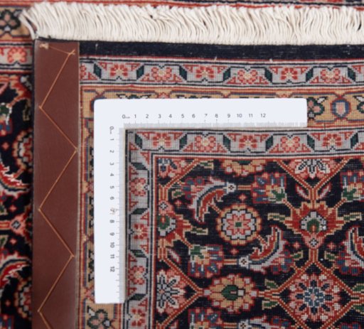 Corner detail of New Tabriz rug showing border pattern and Wool pile