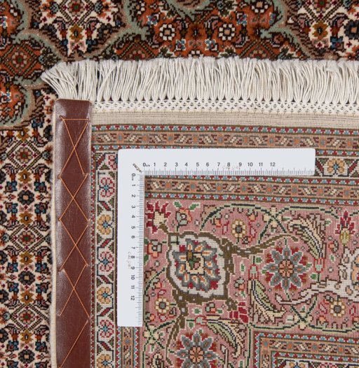 Backside of handmade New Tabriz rug showing knot structure and weave density