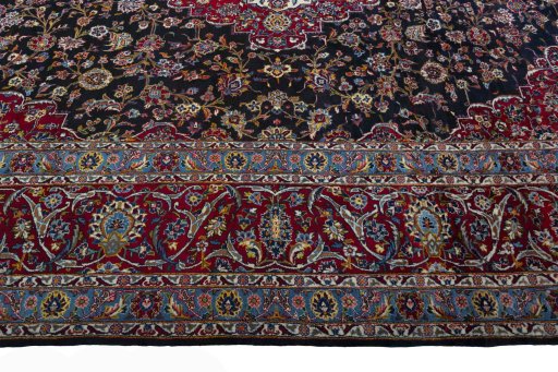 Corner detail of 2000s Yazd rug showing border pattern and Wool pile