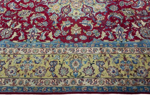 Corner detail of 2000s Yazd rug showing border pattern and Wool pile