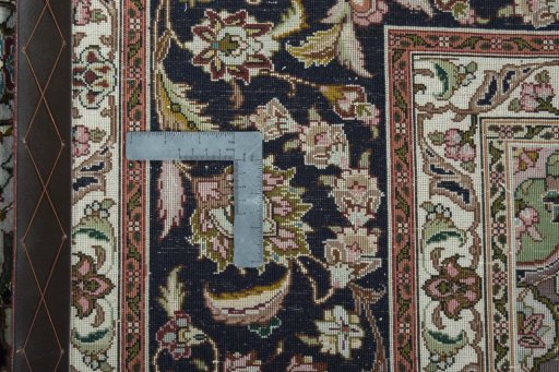 Backside of handmade 2000s Tabriz 50/60/70 Raj rug showing knot structure and weave density