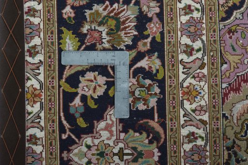 Backside of handmade 2000s Tabriz 50/60/70 Raj rug showing knot structure and weave density