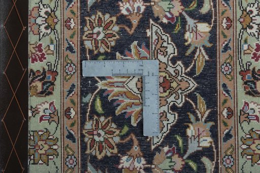 Backside of handmade 2000s Tabriz 50/60/70 Raj rug showing knot structure and weave density
