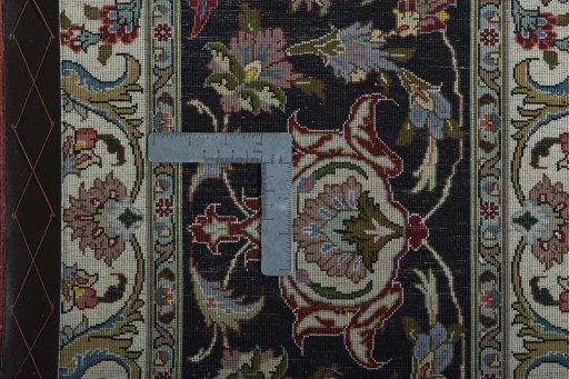 Backside of handmade 2000s Tabriz 50/60/70 Raj rug showing knot structure and weave density