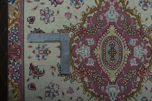 Corner detail of 2000s Tabriz 50/60/70 Raj rug showing border pattern and Cork pile
