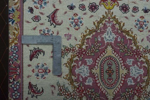 Corner detail of 2000s Tabriz 50/60/70 Raj rug showing border pattern and Cork pile