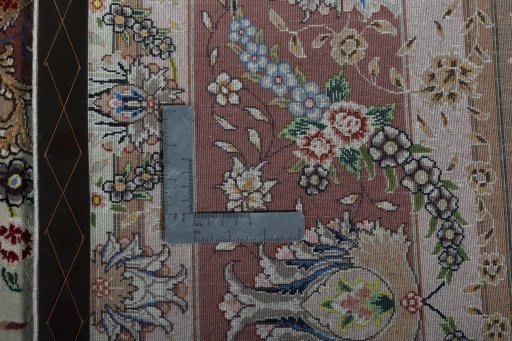 Backside of handmade 2000s Tabriz 50/60/70 Raj rug showing knot structure and weave density