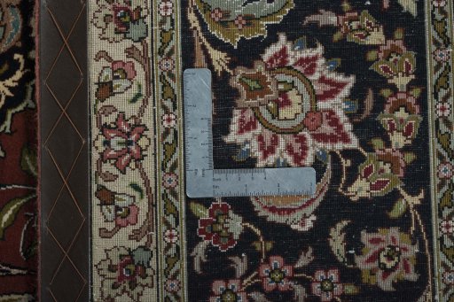 Backside of handmade 2000s Tabriz 50/60/70 Raj rug showing knot structure and weave density