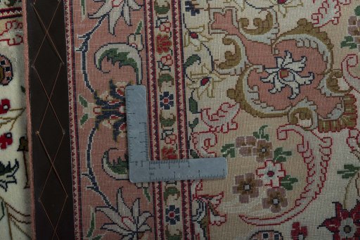Backside of handmade 2000s Tabriz 50/60/70 Raj rug showing knot structure and weave density
