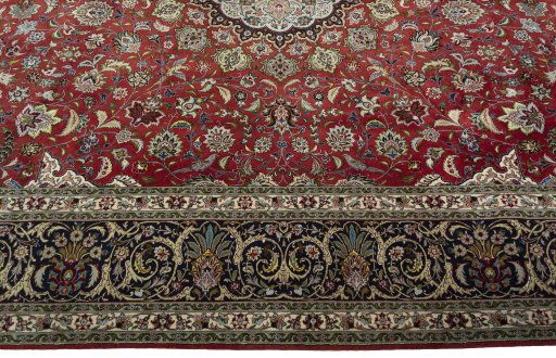 Corner detail of 2000s Tabriz 50/60/70 Raj rug showing border pattern and Cork pile