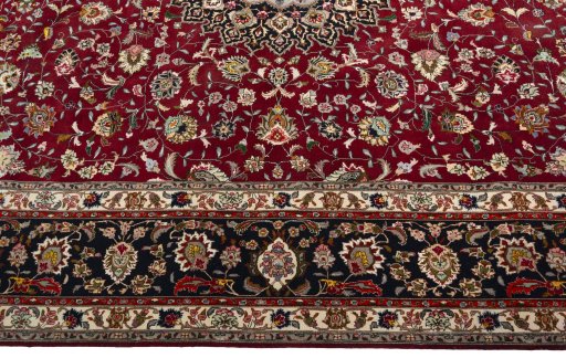 Corner detail of 2000s Tabriz 50/60/70 Raj rug showing border pattern and Cork pile
