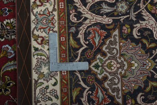 Backside of handmade 2000s Tabriz 50/60/70 Raj rug showing knot structure and weave density