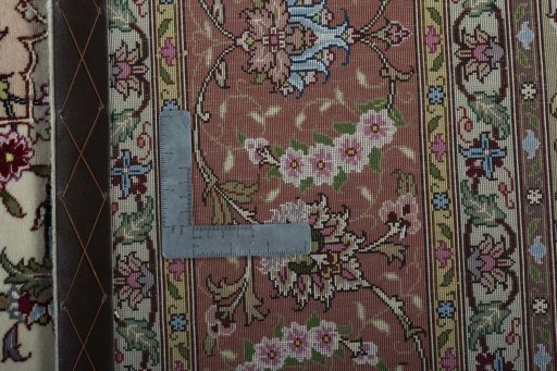 Backside of handmade 2000s Tabriz 50/60/70 Raj rug showing knot structure and weave density