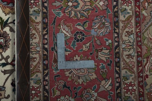 Backside of handmade 2000s Tabriz 50/60/70 Raj rug showing knot structure and weave density