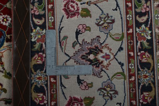 Backside of handmade 2000s Tabriz 50/60/70 Raj rug showing knot structure and weave density