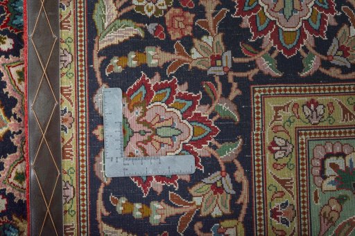 Backside of handmade 2000s Tabriz 50/60/70 Raj rug showing knot structure and weave density