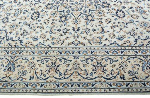 Corner detail of 2000s Kashan rug showing border pattern and Wool pile