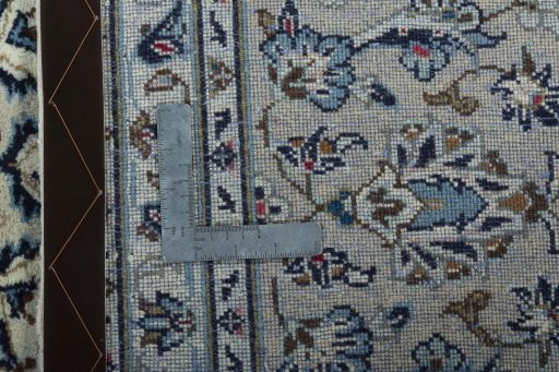 Backside of handmade 2000s Kashan rug showing knot structure and weave density