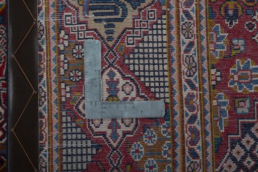 Backside of handmade 2000s Kashan rug showing knot structure and weave density