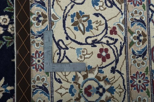 Backside of handmade 2000s Nain rug showing knot structure and weave density