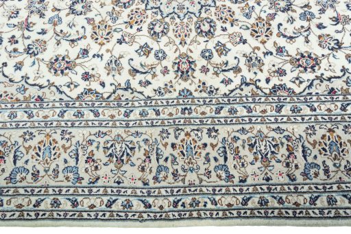 Corner detail of 2000s Kashan rug showing border pattern and Wool pile