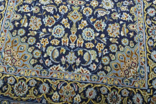 Close-up detail of 2000s Kashan rug from Iran / Persia showing Wool weave
