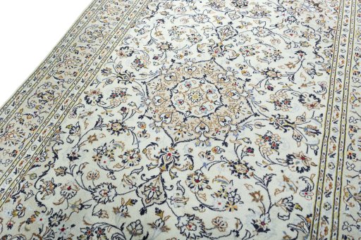 Backside of handmade 2000s Kashan rug showing knot structure and weave density