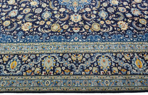 Corner detail of 2000s Kashan rug showing border pattern and Wool pile