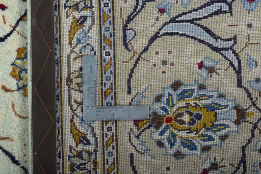 Backside of handmade 2000s Kashan rug showing knot structure and weave density