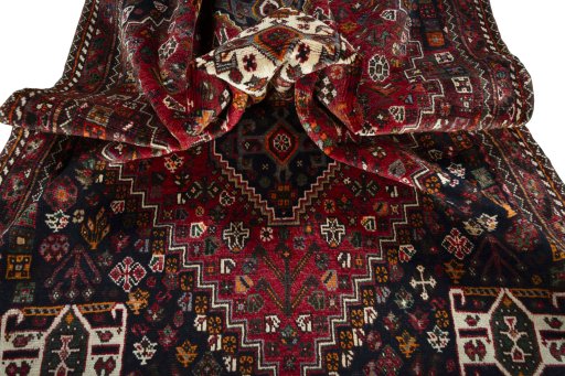 Corner detail of 2000s Shiraz rug showing border pattern and Wool pile