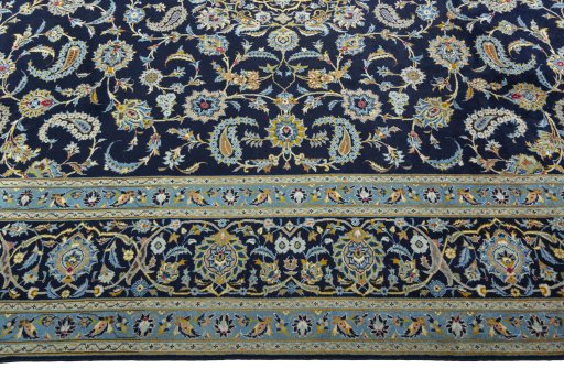 Corner detail of 2000s Kashan rug showing border pattern and Wool pile