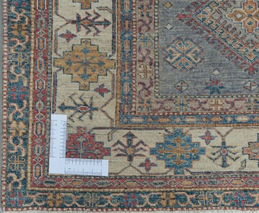 Corner detail of New Kazak rug showing border pattern and Wool pile